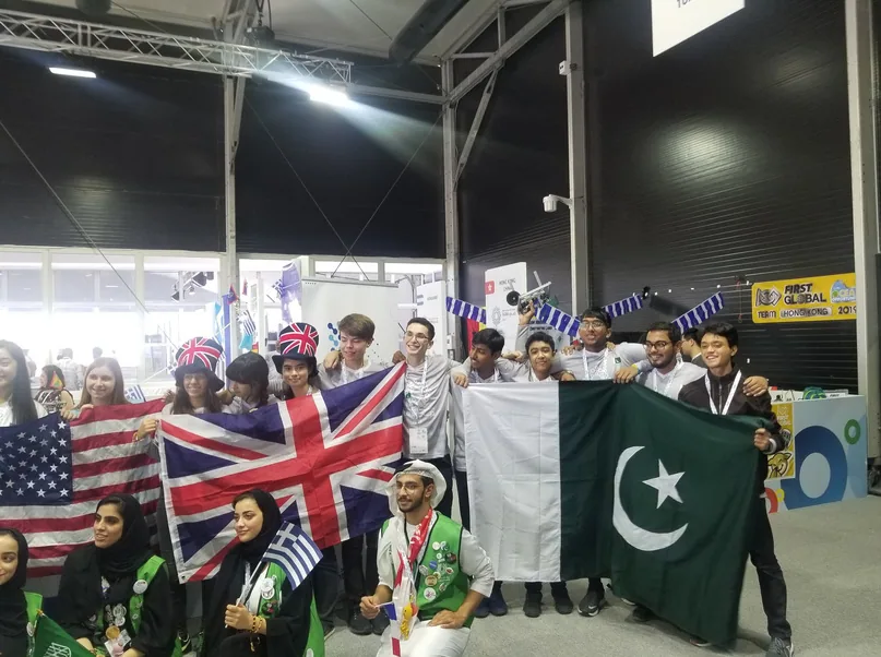 International teams celebrating together with Pakistan's flag