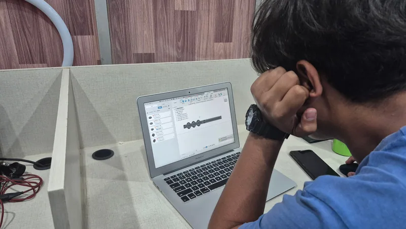 A student working on a CAD and modelling task