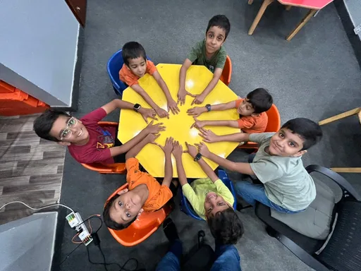 Young learners collaborating around a classroom challenge